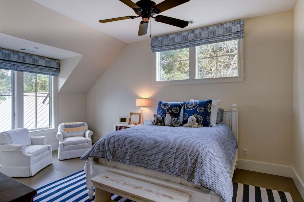 Hip to gable loft conversion in London transformed into child’s bedroom with brown wooden flooring and cream-painted walls